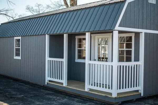 A small house with a porch and a blue roof.