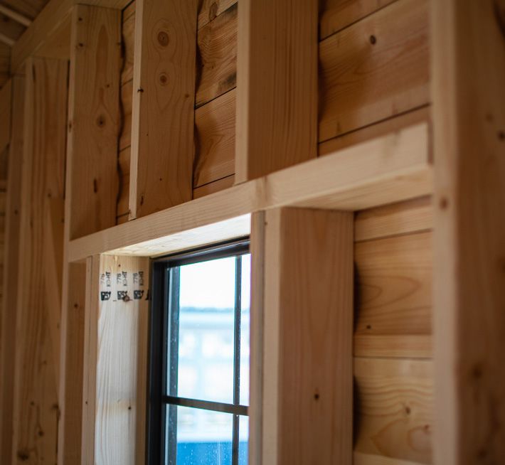 A window is being built into a wooden wall.