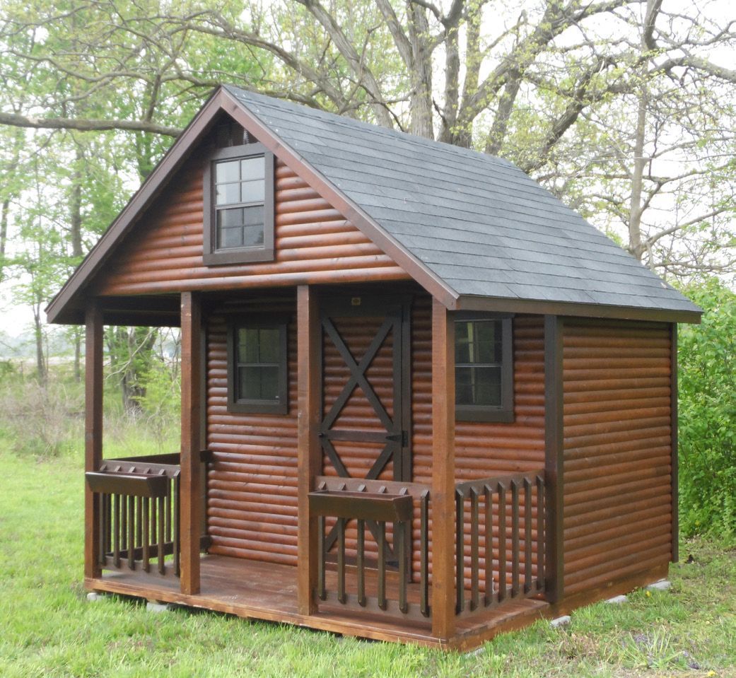 A small log cabin with a porch and a window
