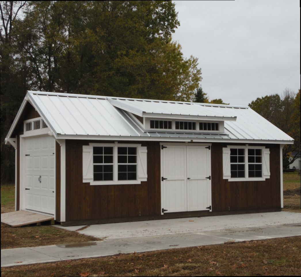 A brown and white shed with a white roof