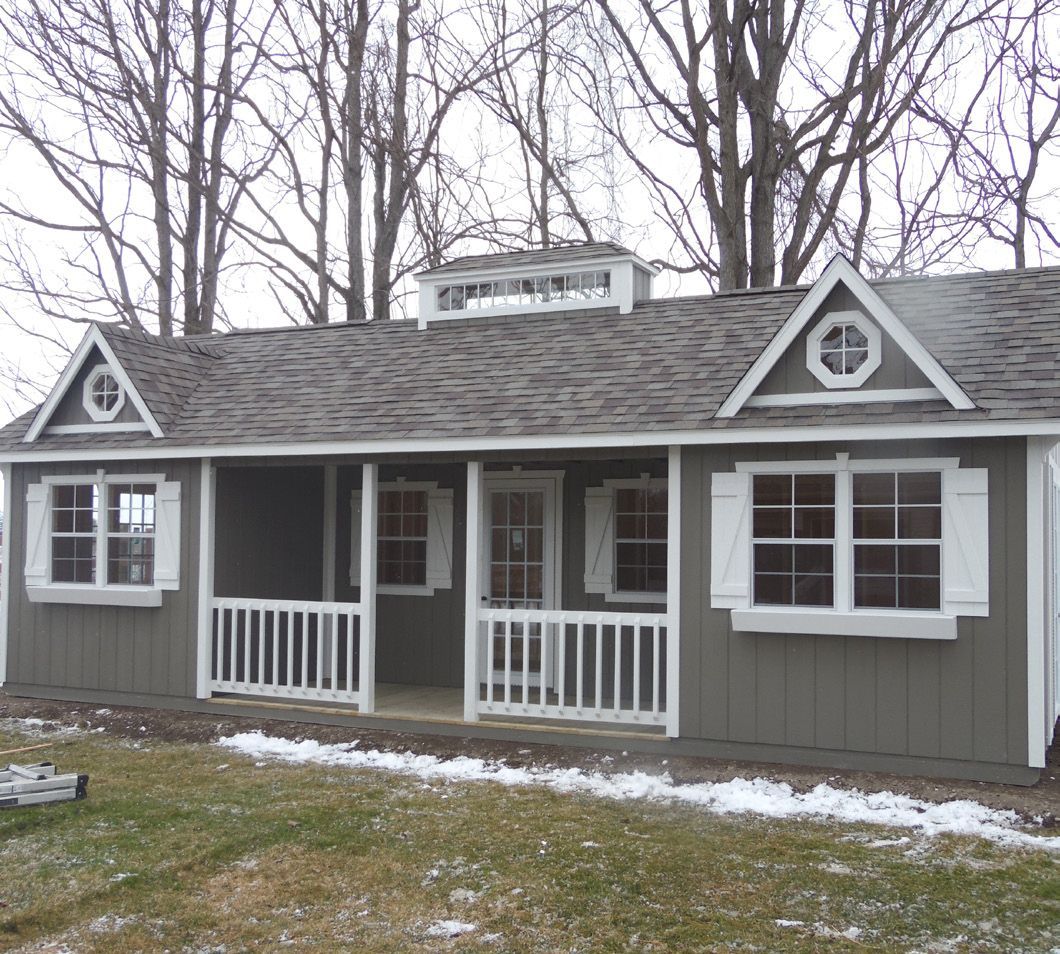 A small house with a porch and a roof