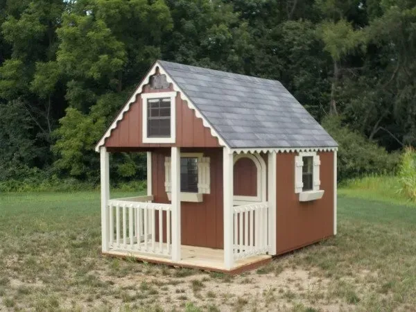 A small brown and white playhouse with a porch