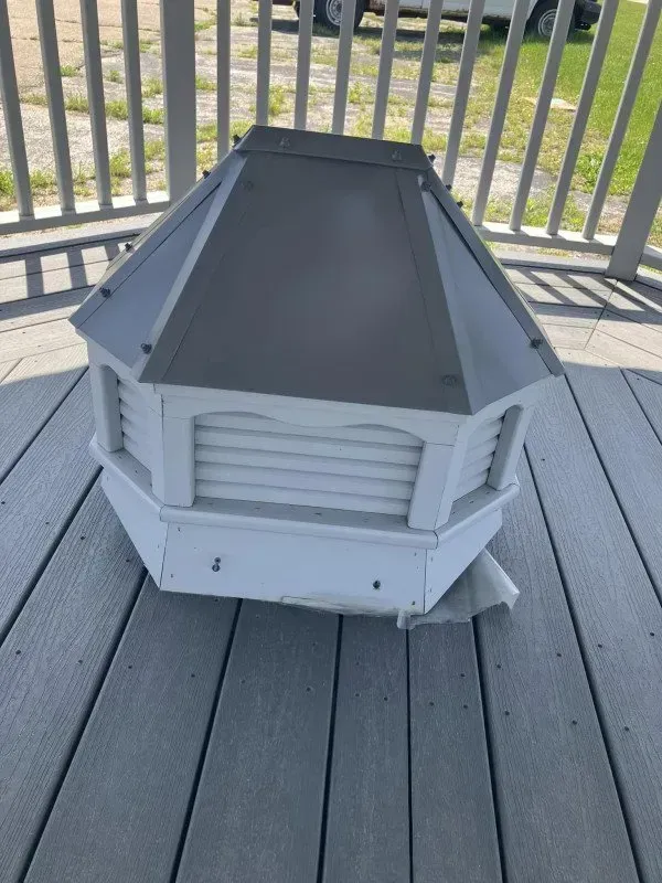 A white roof sitting on top of a wooden deck.