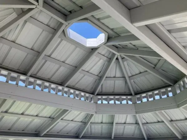 Looking up at the ceiling of a gazebo with a window in the middle