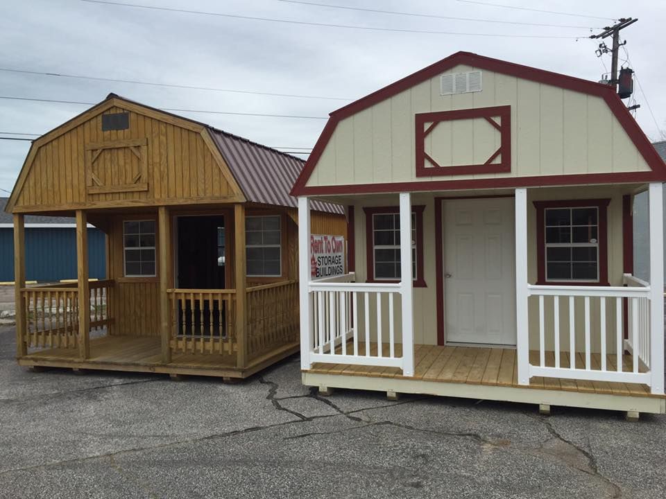 Two sheds one of which has a porch and the other has a red roof