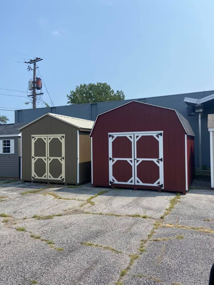 A group of sheds are lined up in a parking lot.