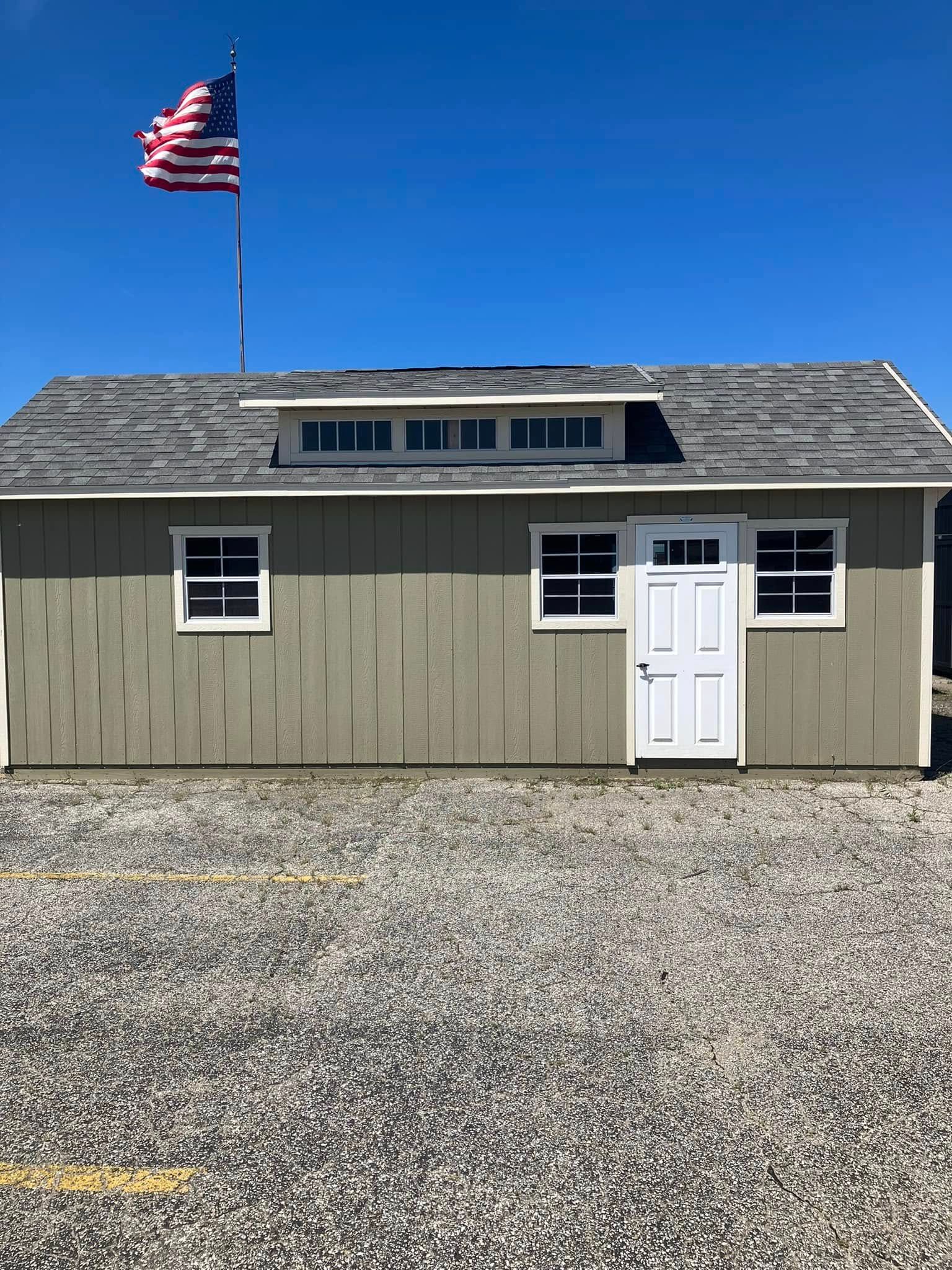 A small house with an american flag on top of it.