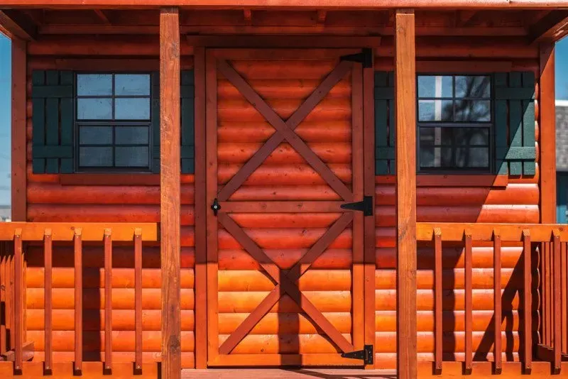 A log cabin with a porch and a door