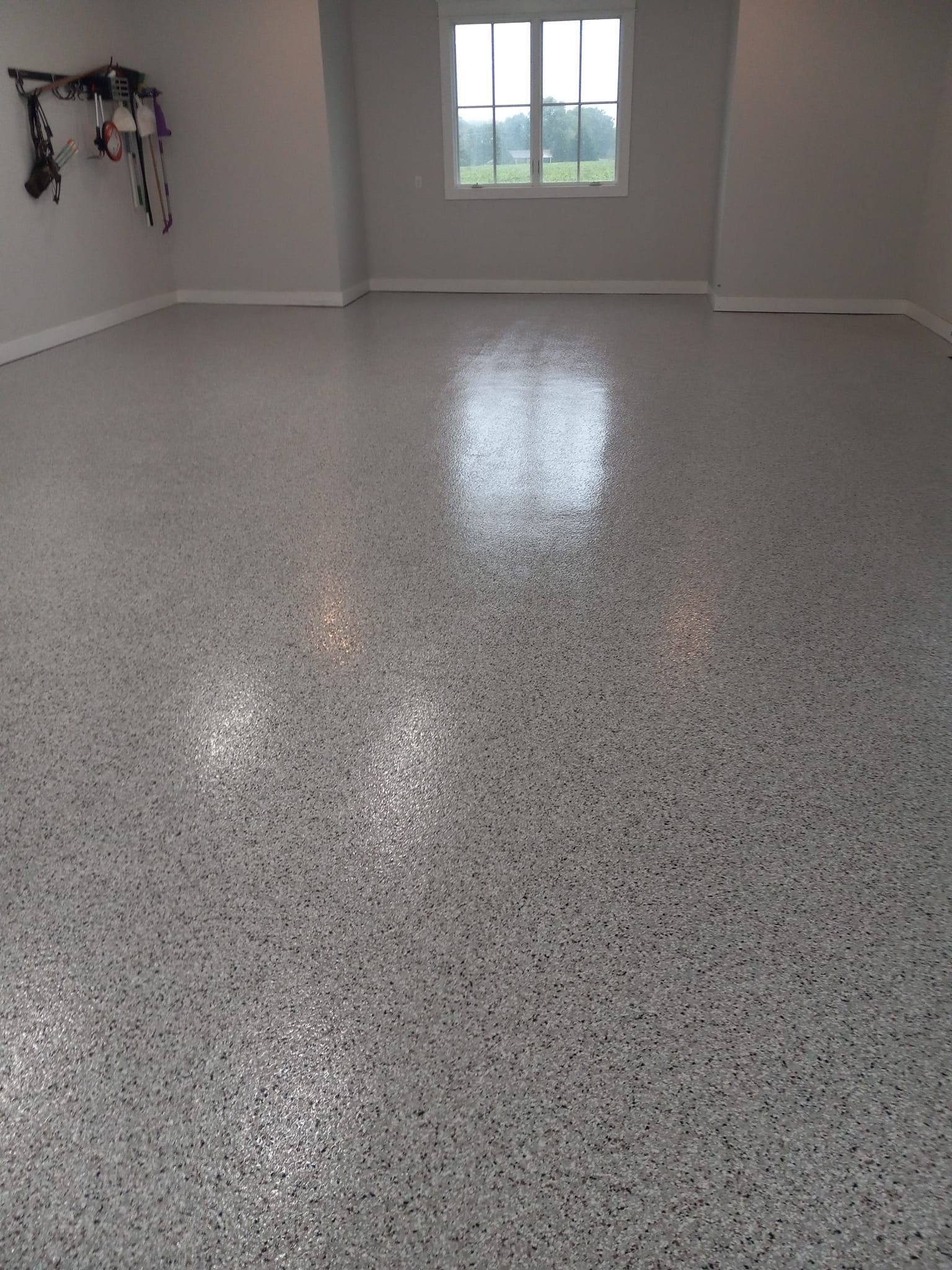 A large room with a shiny floor and a window.