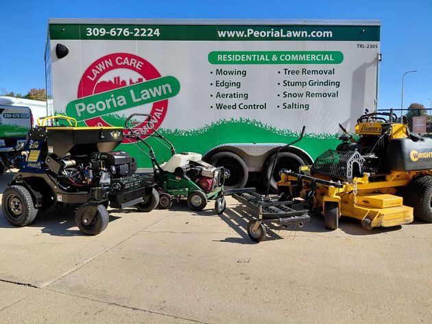 Silver lawn mower on green grass.