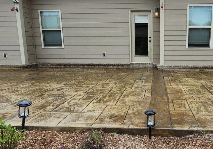 A house with a concrete driveway in front of it