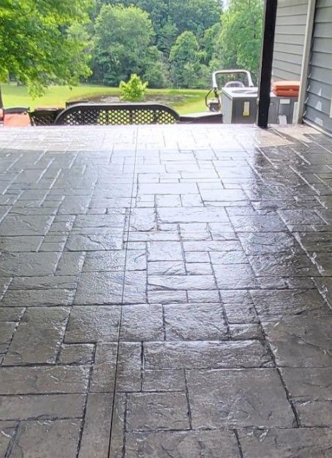 A patio with a view of a field and trees