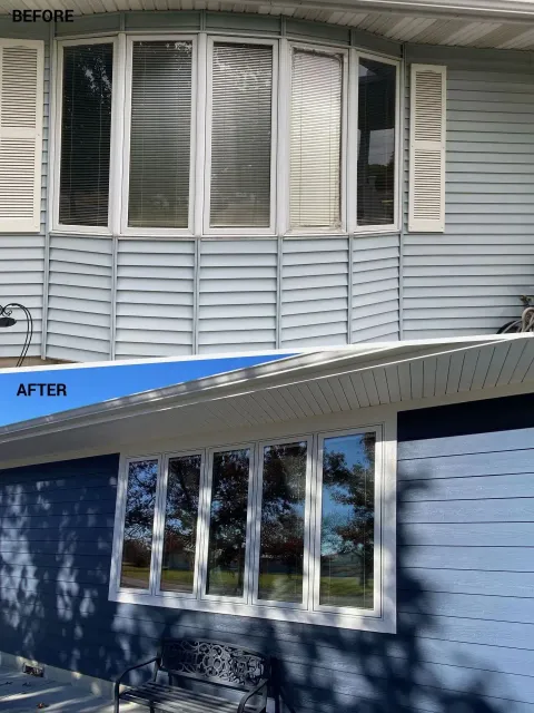 Before and after comparison of a home exterior renovation featuring new navy blue siding and a flat picture window.
