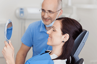 Woman happy with the result with the dentist