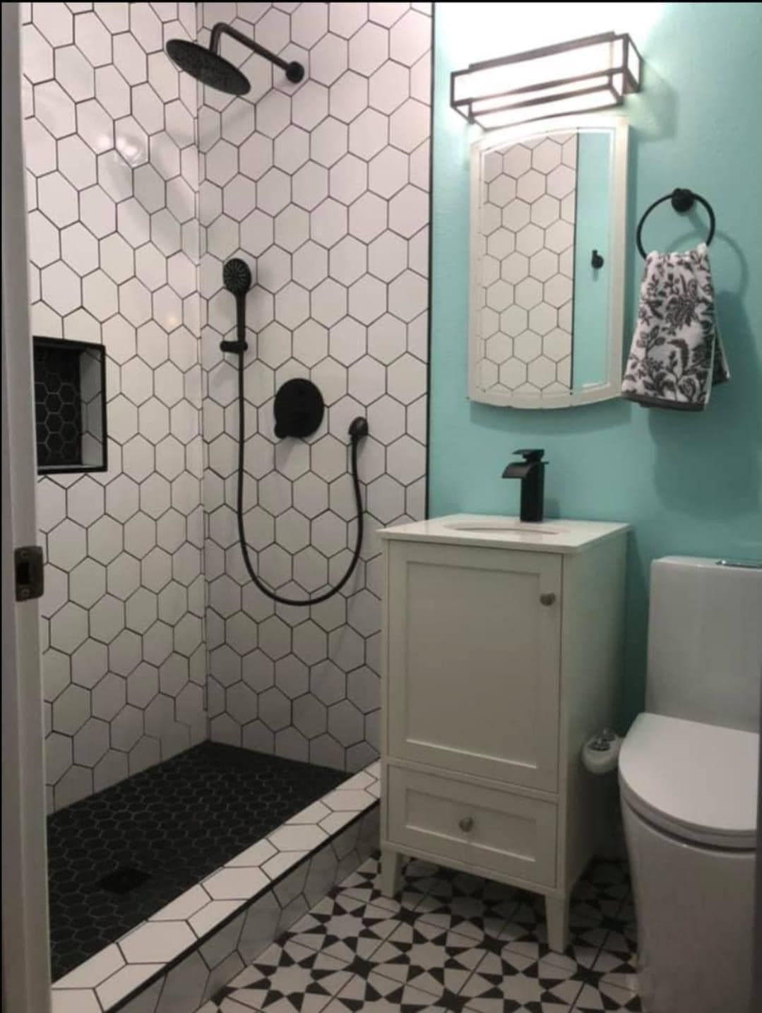 A bathroom with a shower a sink and a toilet