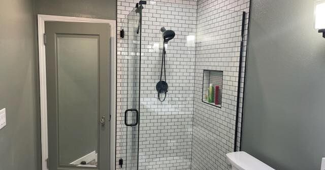 A bathroom with a walk in shower and a toilet.