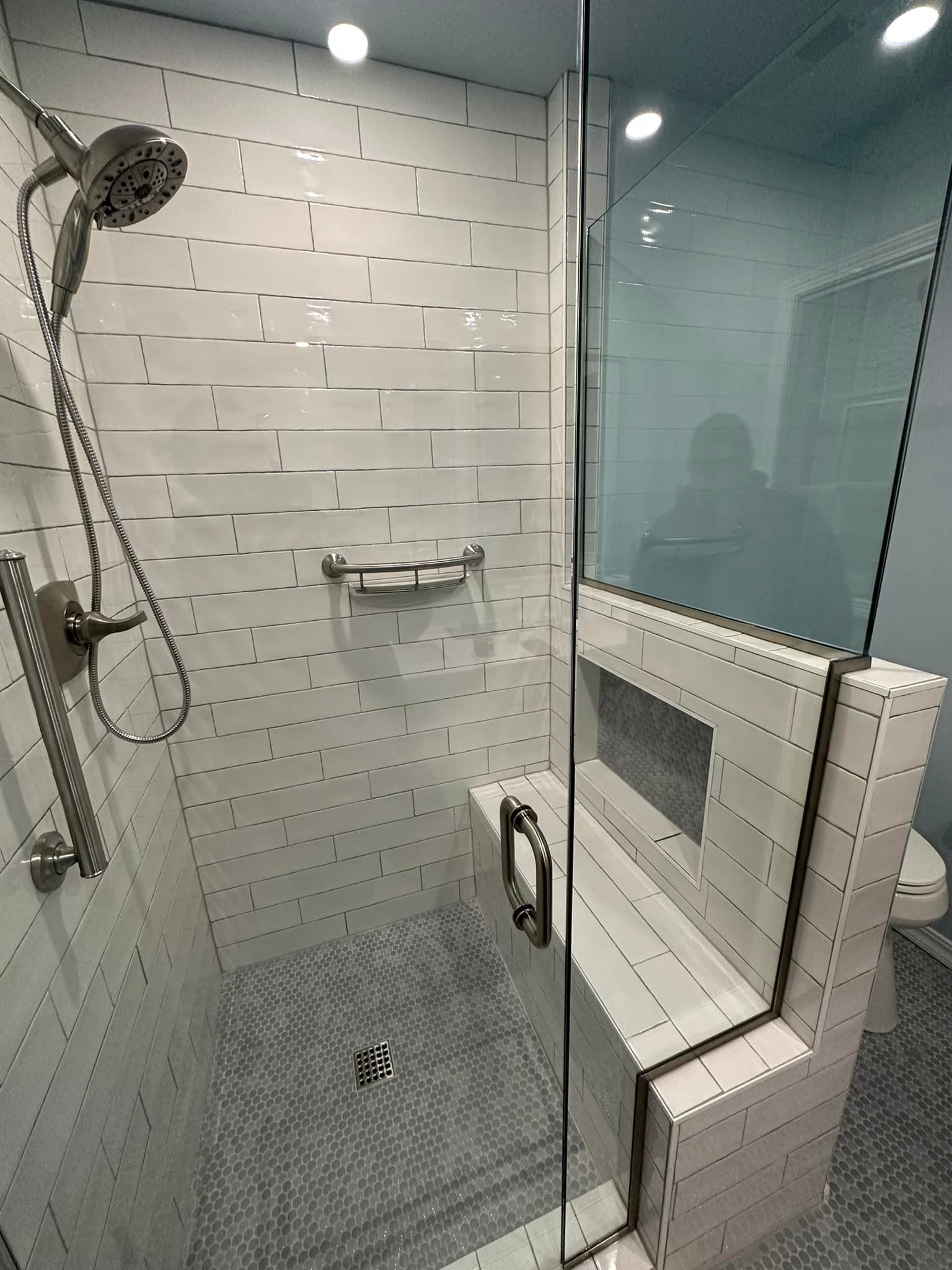 A bathroom with a walk in shower and a toilet.