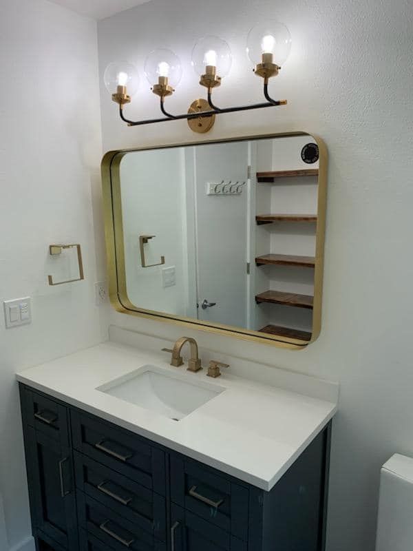 A bathroom with a sink and a mirror above it