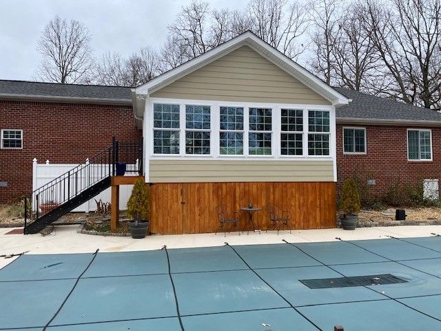 A house with a swimming pool in front of it