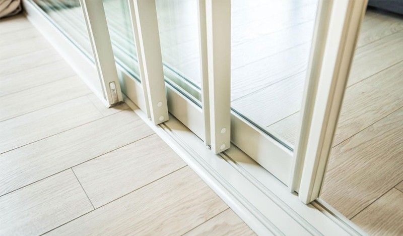 A close up of a sliding glass door in a living room.
