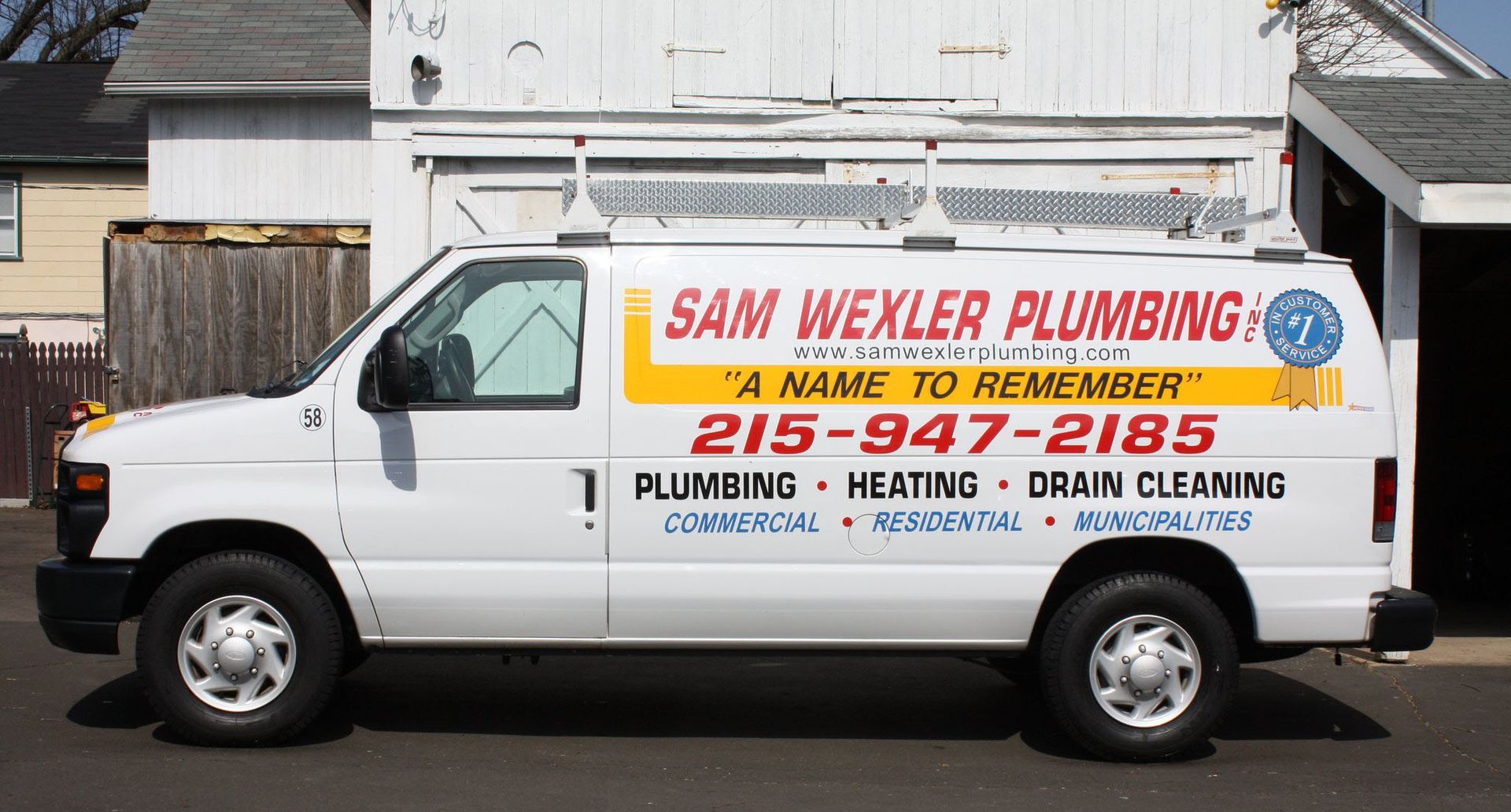 A white van for sam wexler plumbing is parked in front of a house