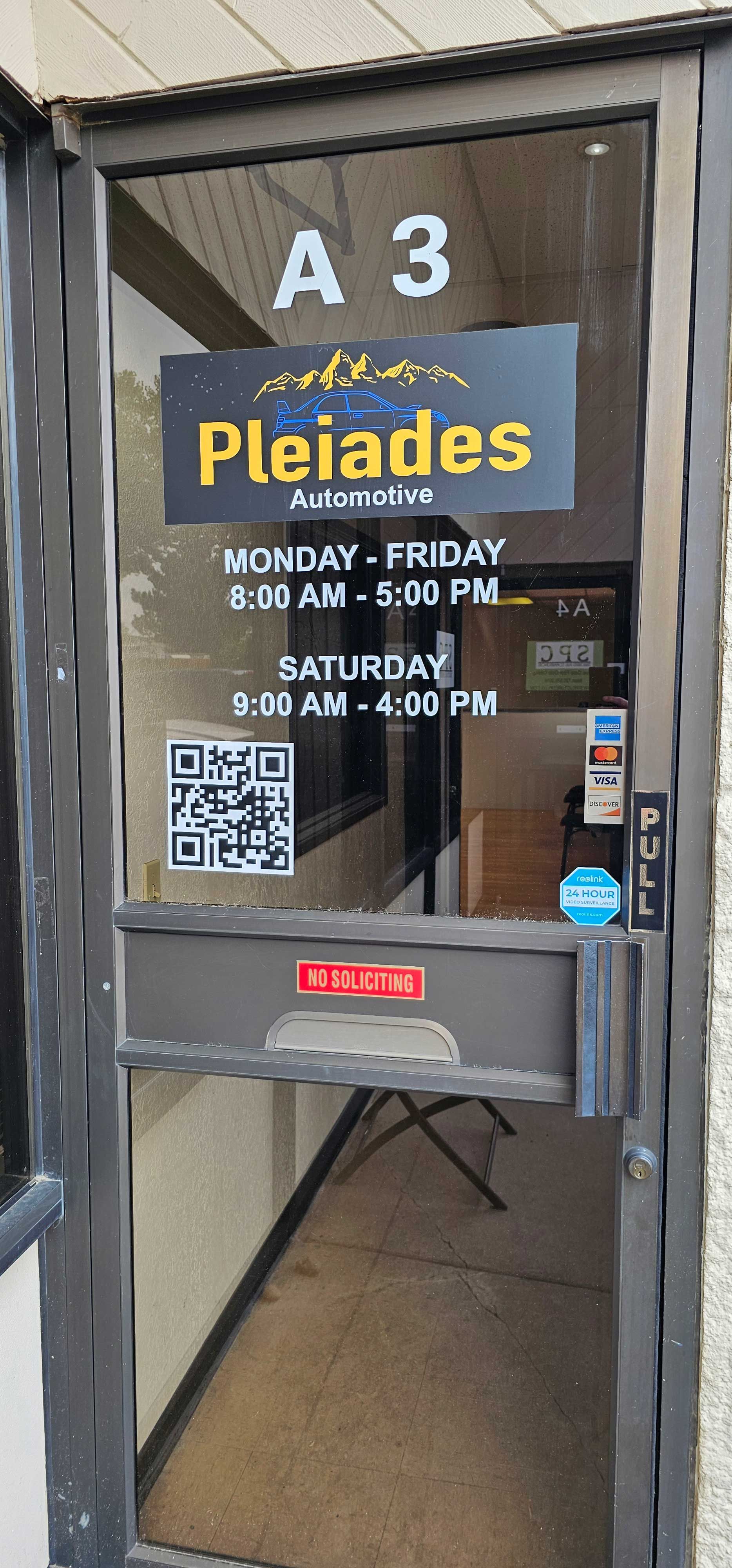 Glass door with “Pleiades” event poster and “A3” room number, with a QR code and posted hours.