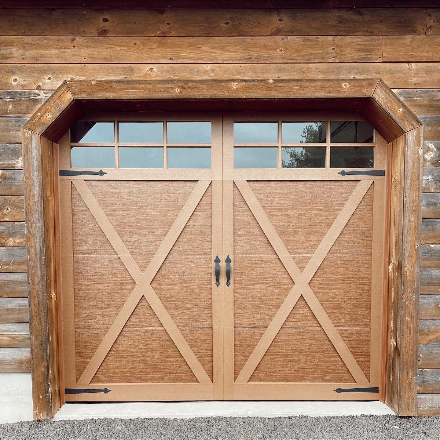A wooden garage door with a x on it