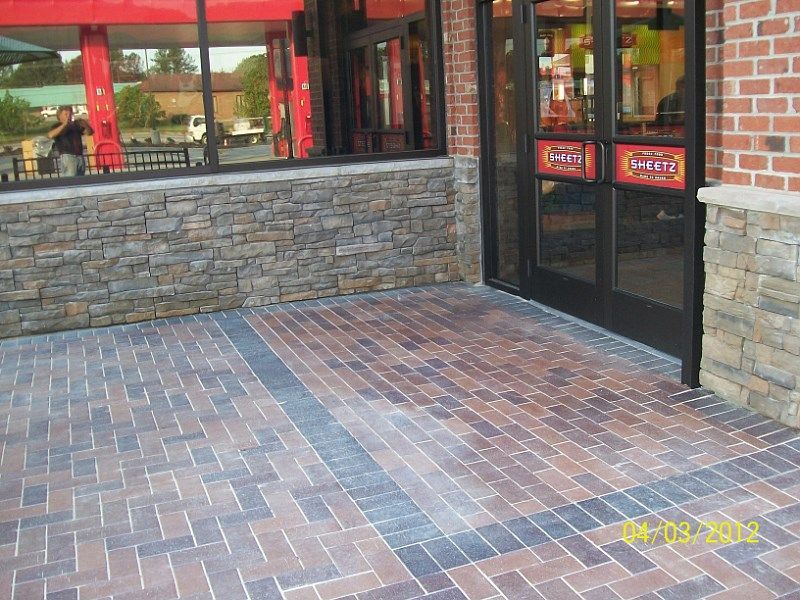 A picture of a brick walkway in front of a restaurant taken in 2012