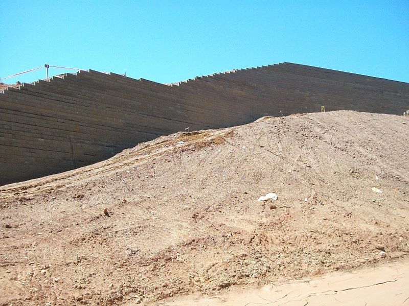 A dirt hill with a mountain in the background