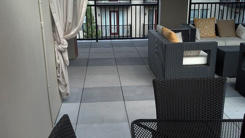 A balcony with wicker furniture and a canopy