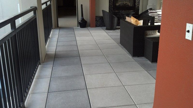 A tiled walkway leading to a living room with a fireplace