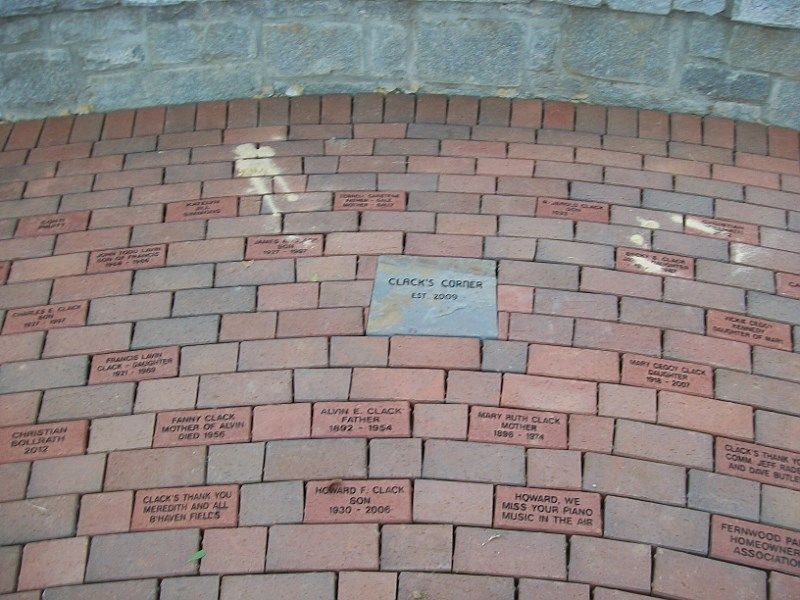 A brick wall with a plaque in the middle that says burch johnson