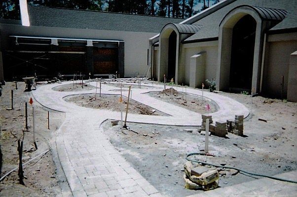 A concrete walkway is being built in front of a building