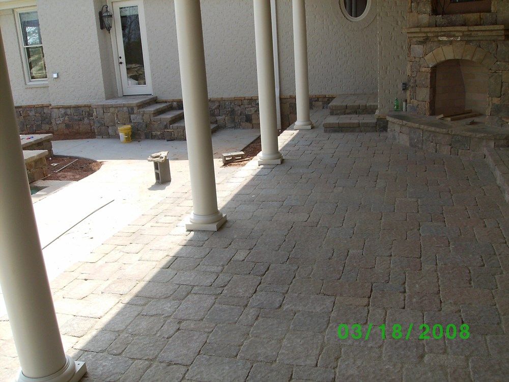 A photo of a patio with columns and a fireplace was taken in 2003