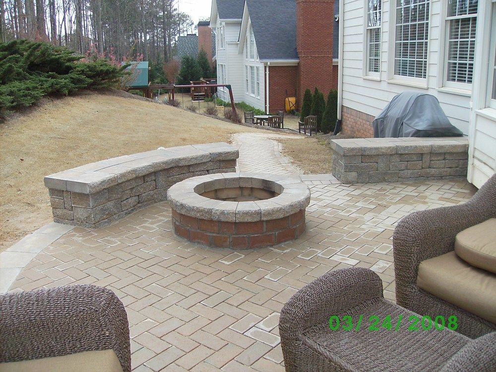 A fire pit sits in the middle of a patio