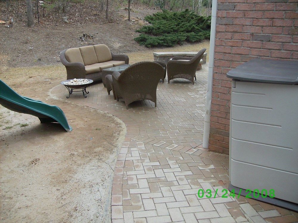 A patio with a couch and chairs and a slide