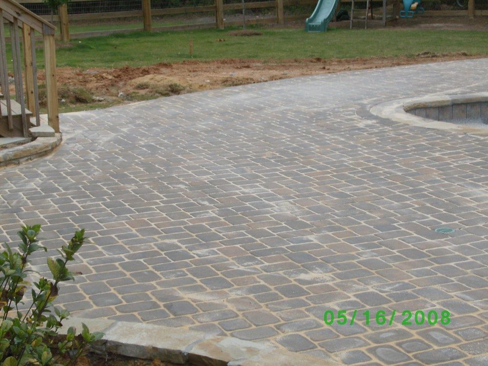 A picture of a patio with a slide in the background taken on 05/16/2008