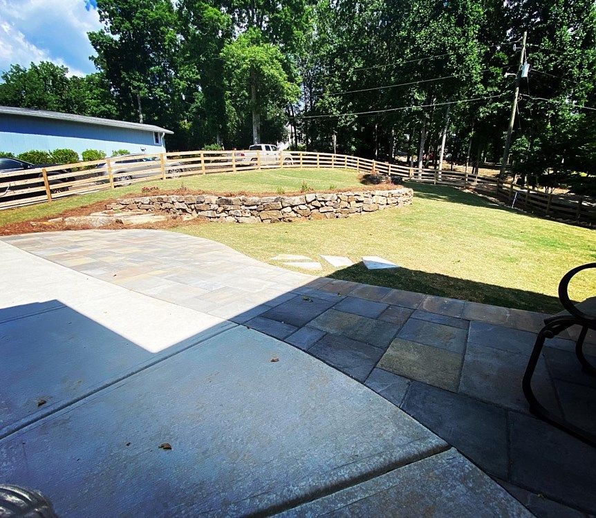 A patio with a chair and a fence in the background