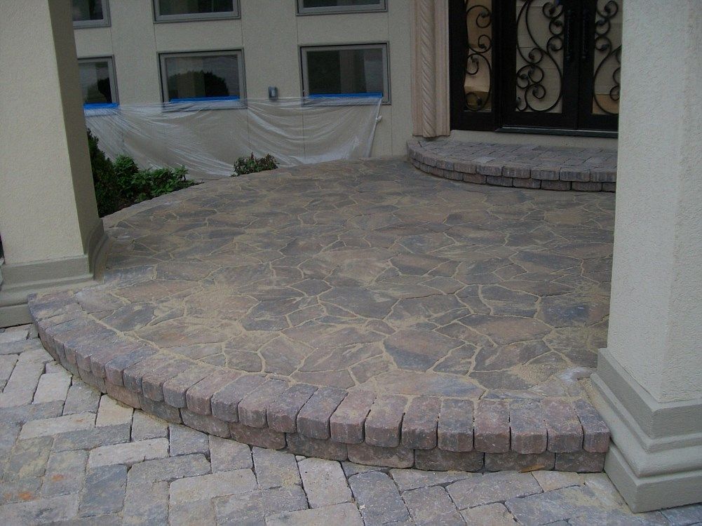 A stone walkway with steps leading to a door