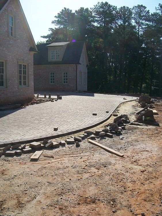 A house with a brick driveway in front of it