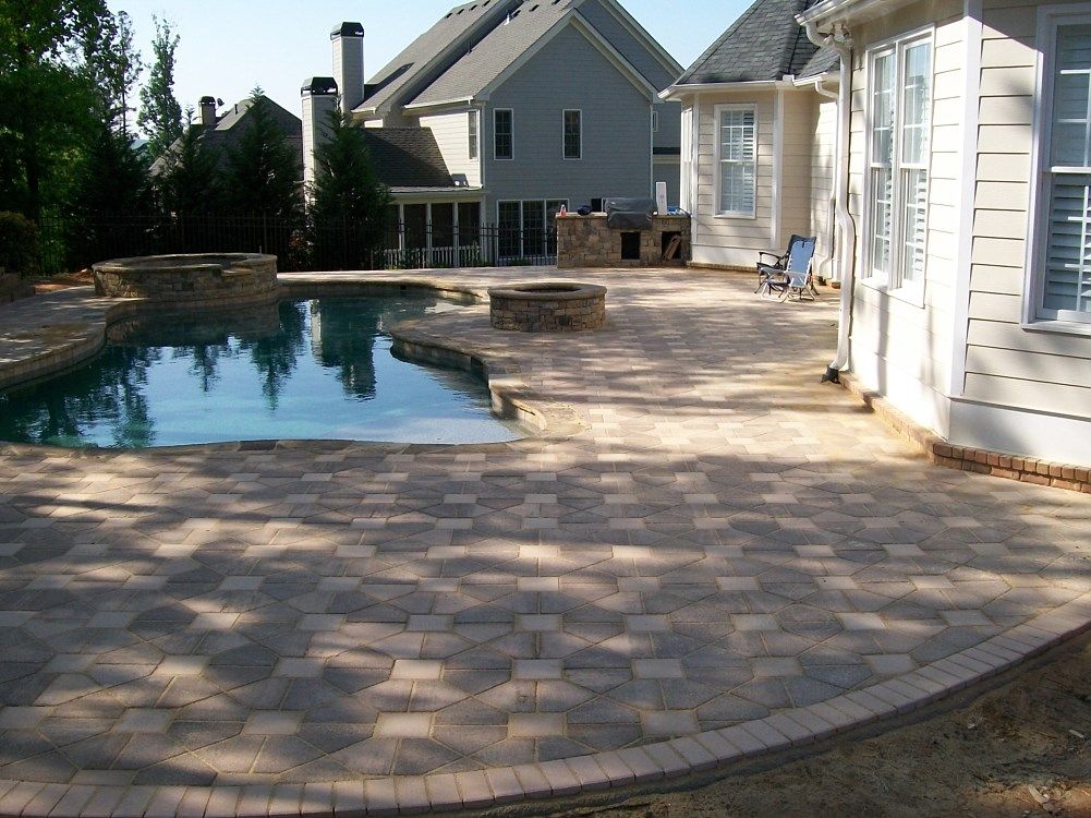 A house with a large swimming pool in front of it