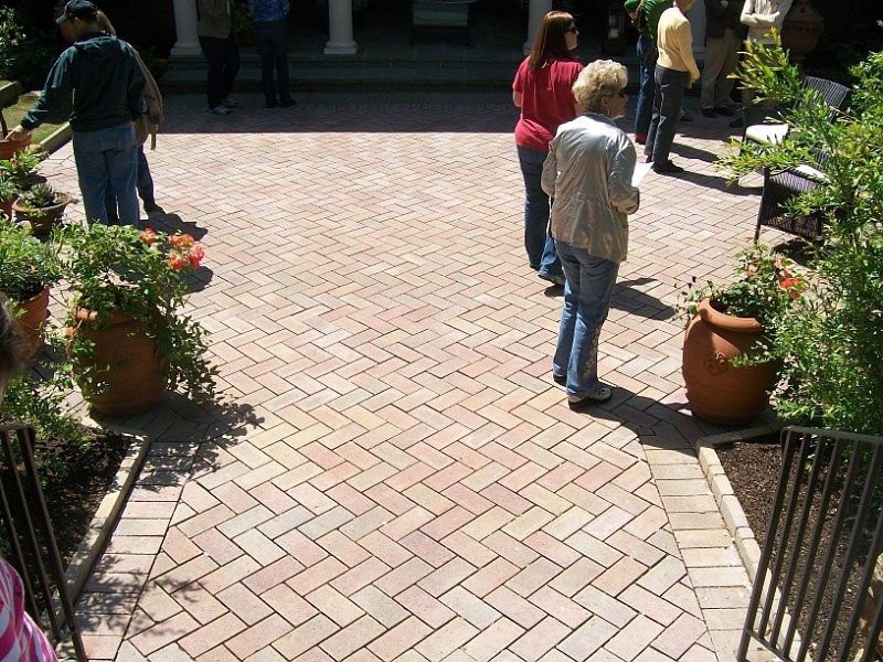 A group of people standing on a brick walkway