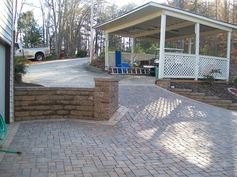 A white truck is parked in a driveway next to a gazebo