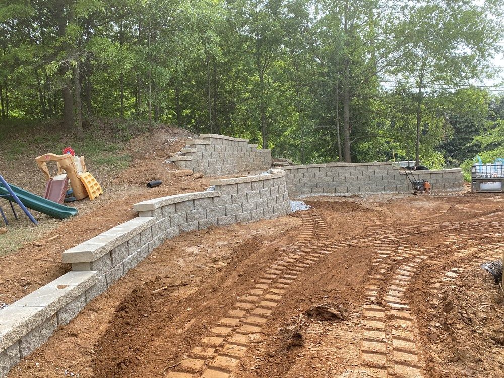A construction site with a slide and a brick wall in the background.