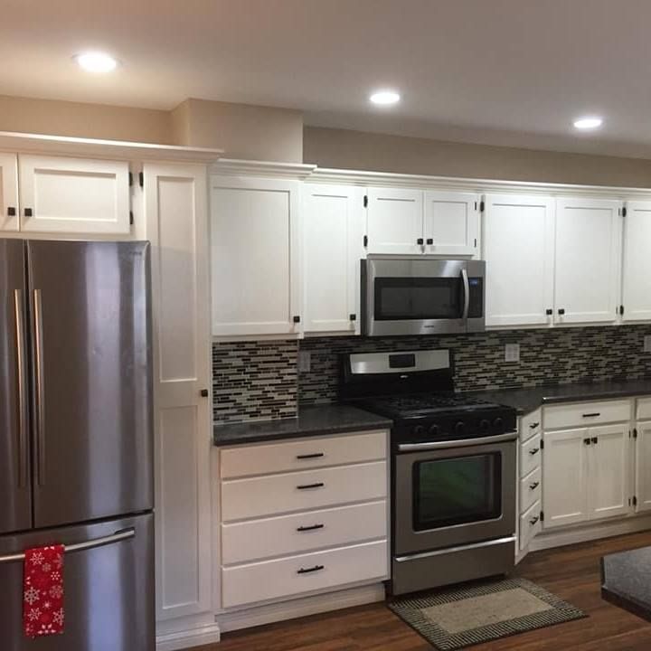 A kitchen with stainless steel appliances and white cabinets