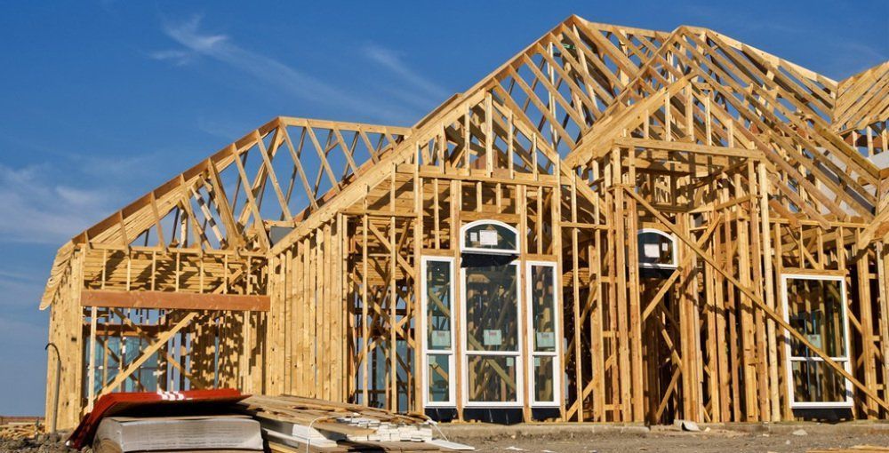 Framing of a house is being built.