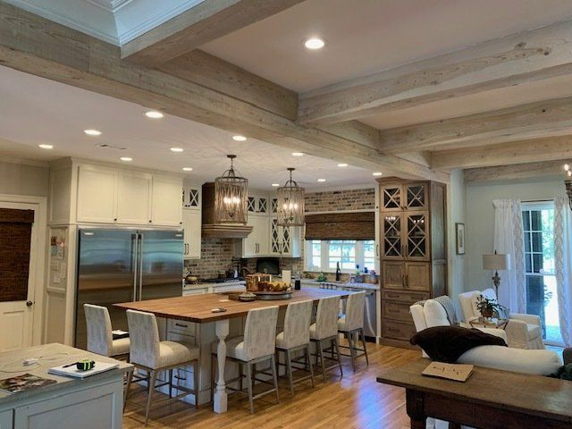 A kitchen with a table and chairs in it and a living room.