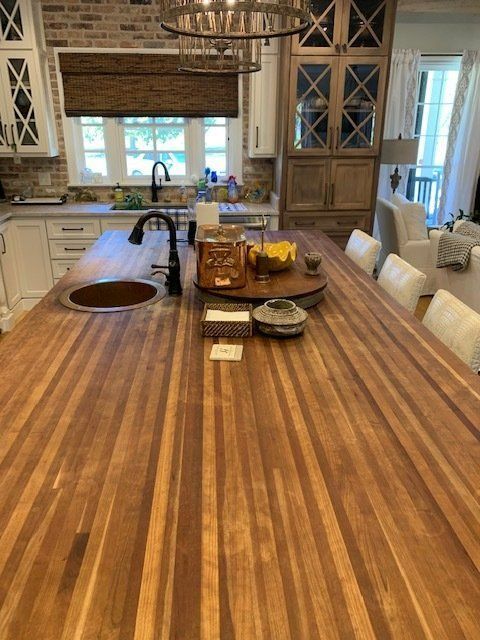 A kitchen with a large wooden table and chairs.