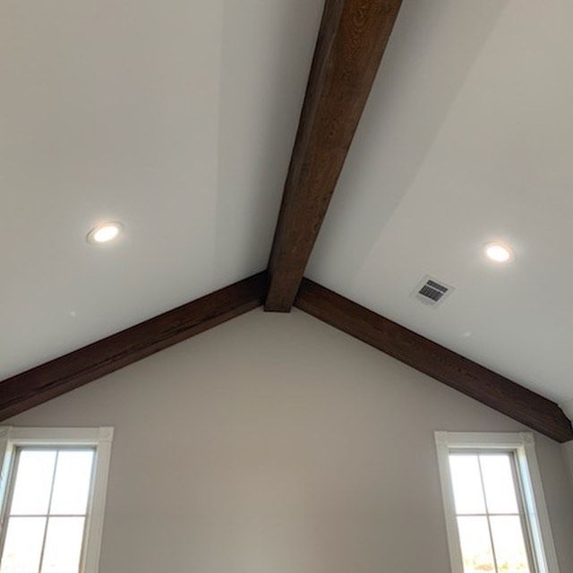a room with a vaulted ceiling and wooden beams