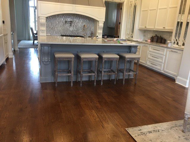 a kitchen with a large island and stools in it